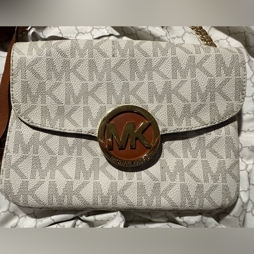 Michael Kors white handbag, or clutch.